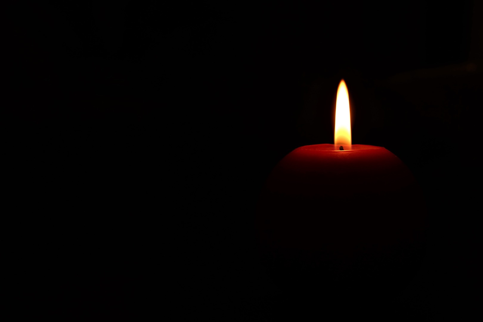 2020Creative_Wallpaper_Lighted_red_candle_on_black_background_145850_